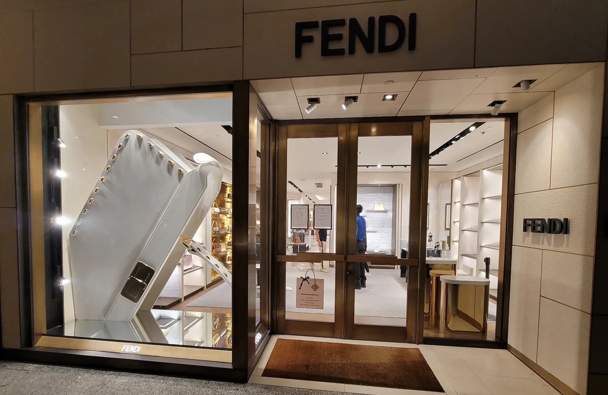 Fendi Bal Harbour storefront at night, its window filled with an oversized white sculpture