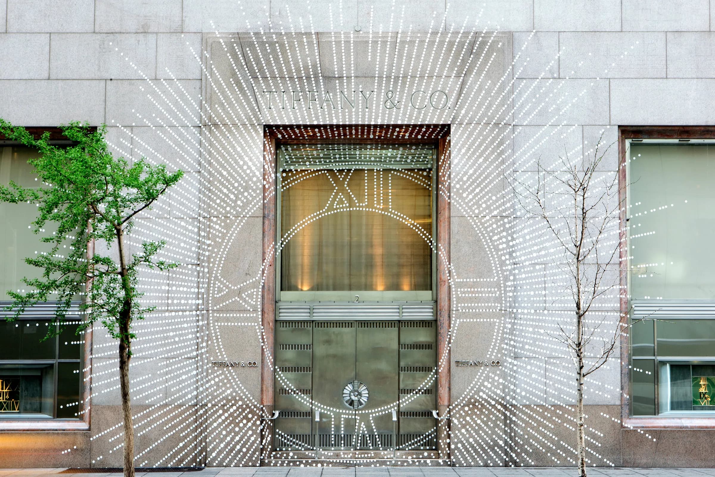 Tiffany & Co. facade with a starburst of lights radiating from the clock-framed entrance