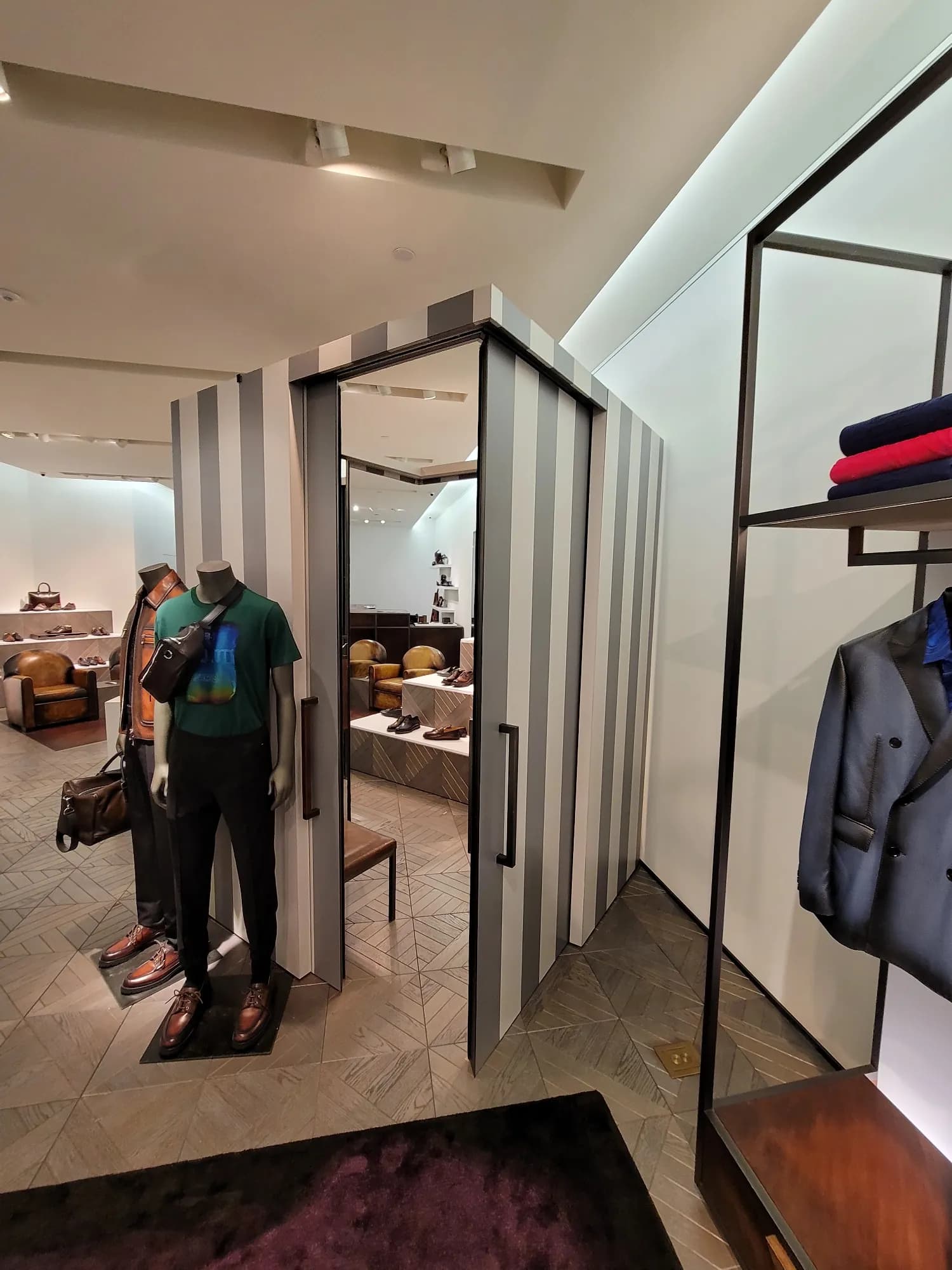 Striped fitting-room structure and styled mannequin in the Berluti Miami boutique