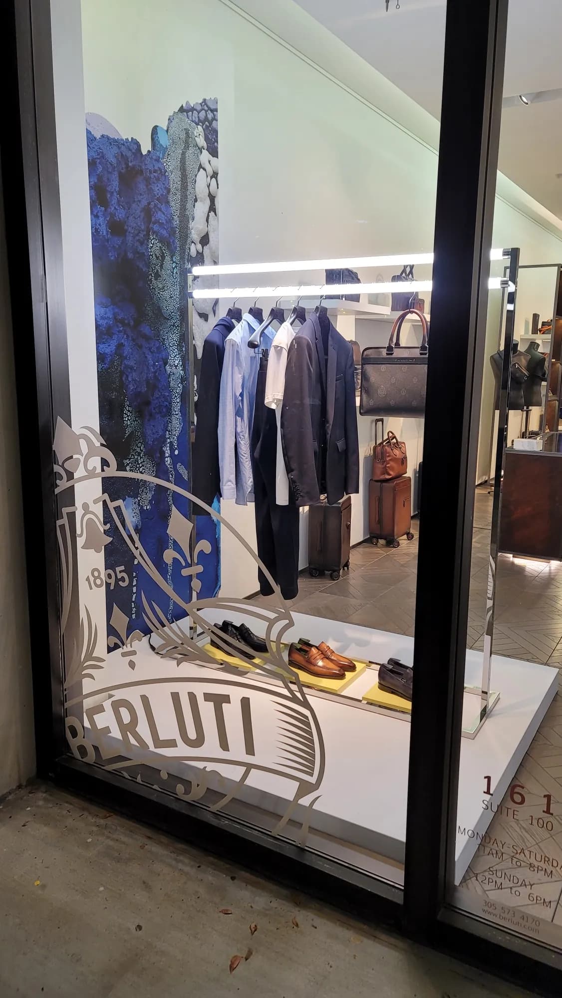 Berluti window with a monumental blue marbled graphic and etched Berluti lettering