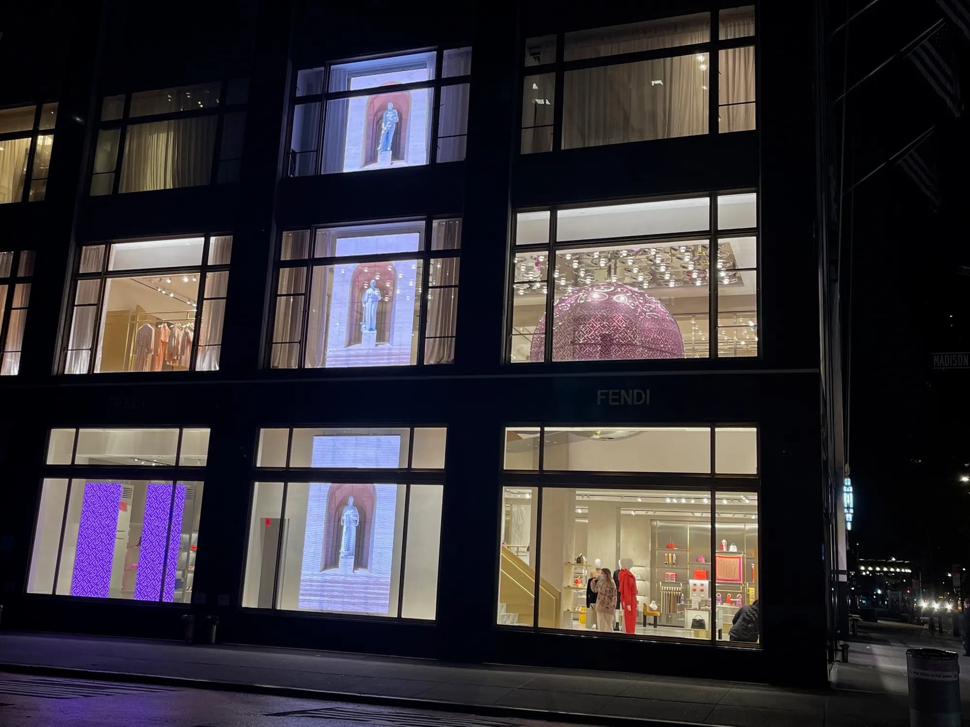 Fendi 57th Street facade at night, LED screens in the ground-floor windows and the pink bubble upstairs