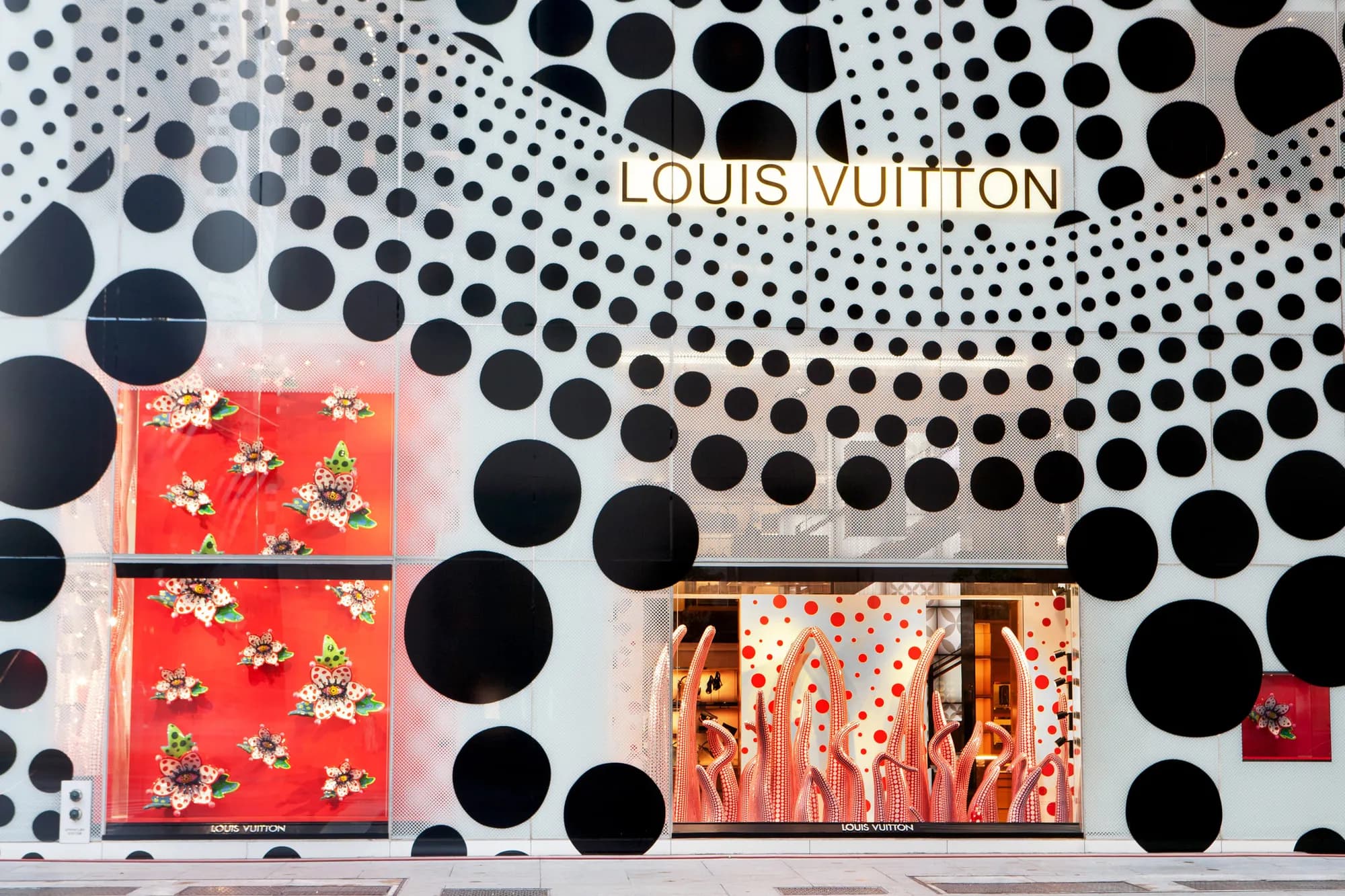 Close view of the polka-dot Louis Vuitton facade wrap framing red holiday windows