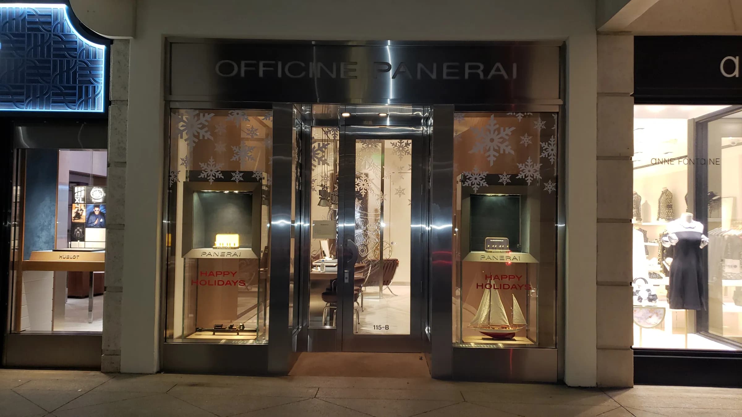 Officine Panerai boutique in Palm Beach at night with snowflake decals and Happy Holidays window graphics, holiday 2020
